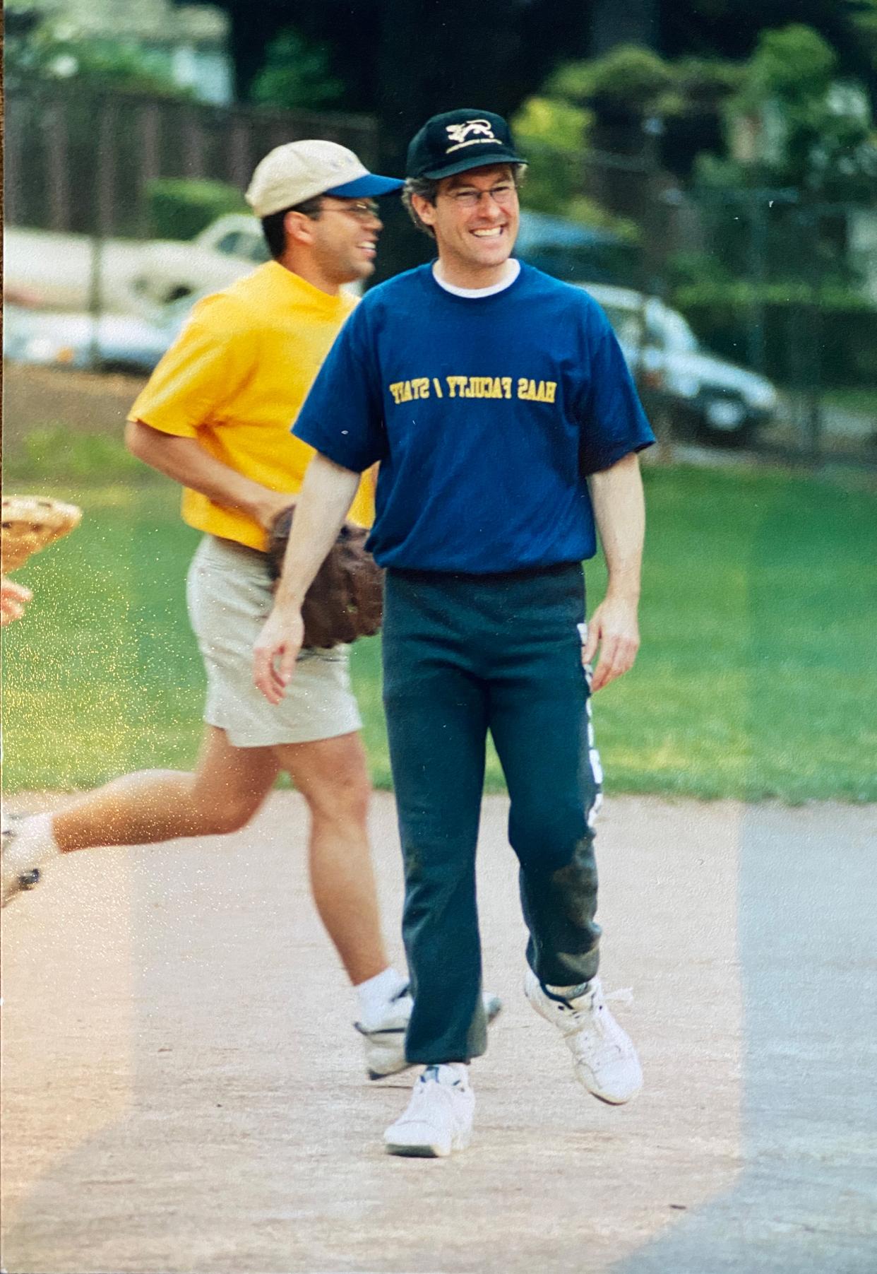 Two men on a softball field in a photo from the 90s